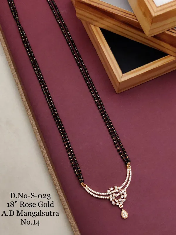 https://d1311wbk6unapo.cloudfront.net/NushopCatalogue/tr:f-webp,w-600,fo-auto/D-NO-S-023 ROSE GOLD AD 18 FANCY MANGALSUTRA_1684936623088_fbtor8xuavet9eo.jpg__Ketmera